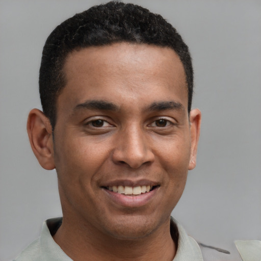 Joyful latino young-adult male with short  brown hair and brown eyes