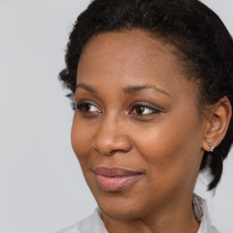 Joyful black adult female with short  brown hair and brown eyes