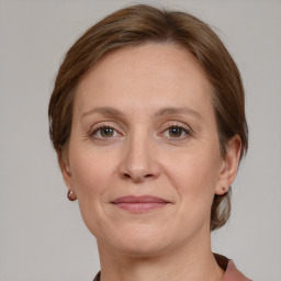 Joyful white adult female with medium  brown hair and grey eyes