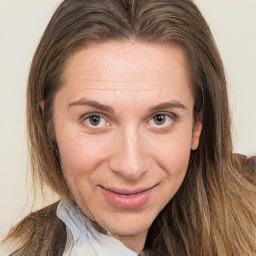 Joyful white adult female with long  brown hair and brown eyes