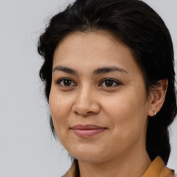 Joyful latino young-adult female with medium  brown hair and brown eyes