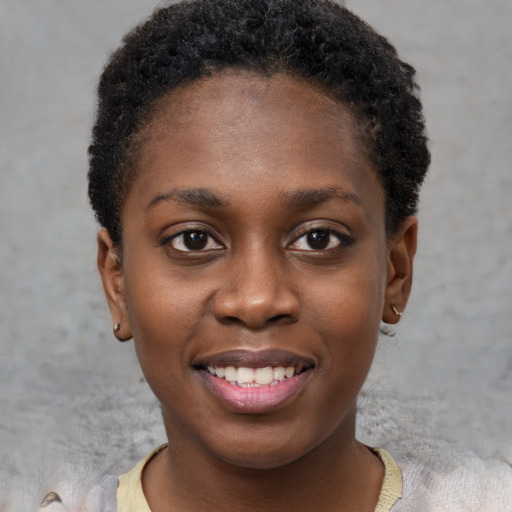 Joyful black young-adult female with short  brown hair and brown eyes