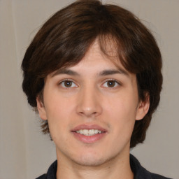 Joyful white young-adult male with medium  brown hair and brown eyes