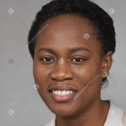 Joyful black young-adult female with short  black hair and brown eyes