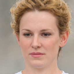 Joyful white young-adult female with medium  brown hair and blue eyes