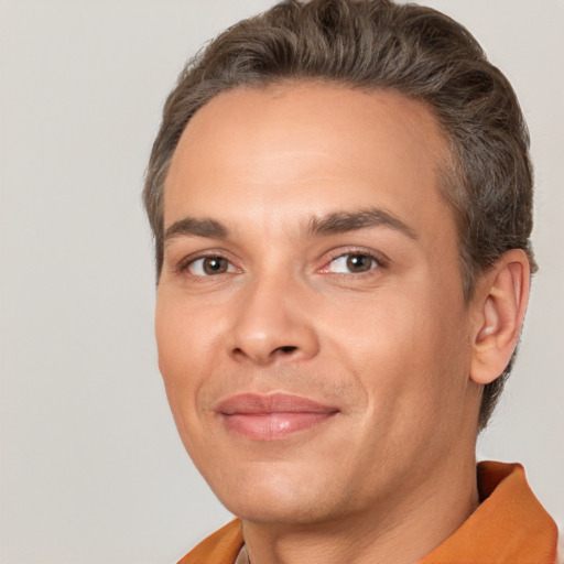 Joyful white adult male with short  brown hair and brown eyes