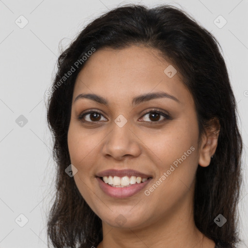 Joyful latino young-adult female with long  brown hair and brown eyes