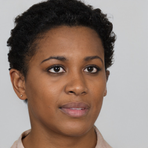 Joyful black young-adult female with short  brown hair and brown eyes