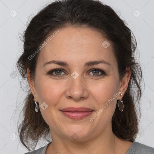 Joyful white adult female with medium  brown hair and grey eyes