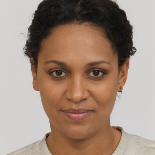Joyful black adult female with short  brown hair and brown eyes