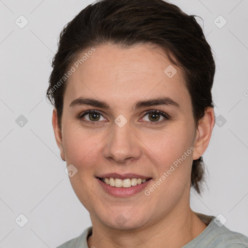 Joyful white young-adult female with short  brown hair and grey eyes