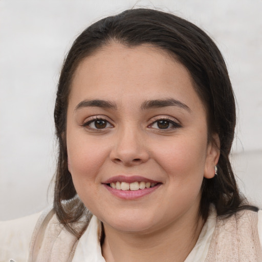 Joyful white young-adult female with medium  brown hair and brown eyes