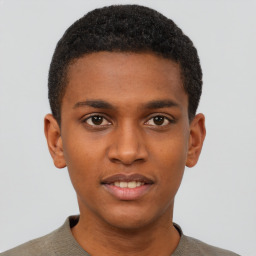 Joyful black young-adult male with short  brown hair and brown eyes