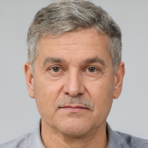 Neutral white middle-aged male with short  gray hair and brown eyes