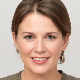 Joyful white young-adult female with medium  brown hair and grey eyes