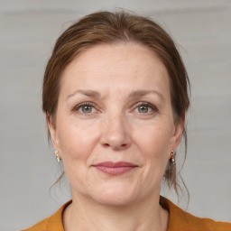 Joyful white adult female with medium  brown hair and grey eyes