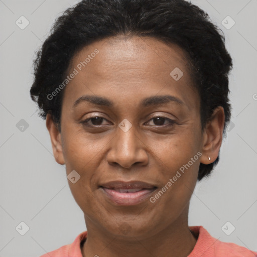 Joyful black adult female with short  black hair and brown eyes