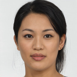 Joyful asian young-adult female with medium  brown hair and brown eyes