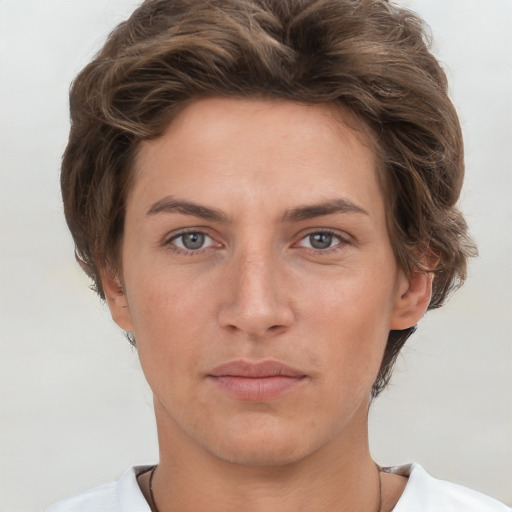 Joyful white young-adult female with short  brown hair and grey eyes