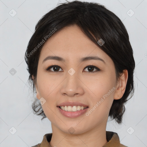 Joyful asian young-adult female with medium  black hair and brown eyes