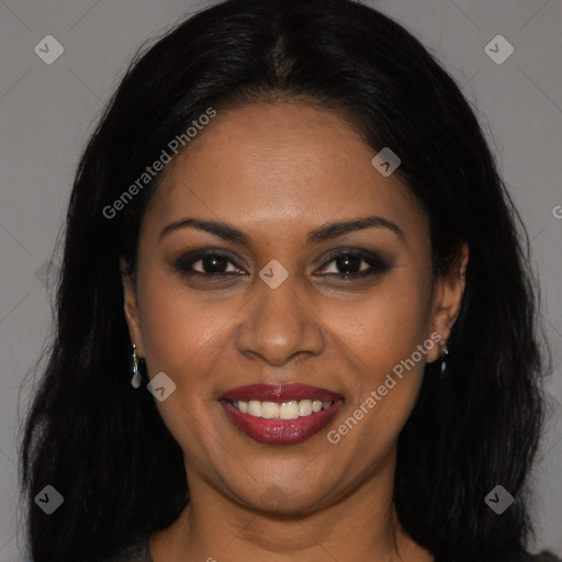 Joyful black young-adult female with long  brown hair and brown eyes