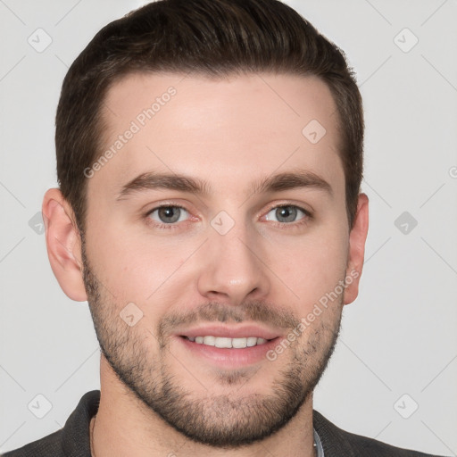 Joyful white young-adult male with short  brown hair and grey eyes