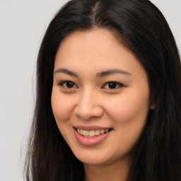 Joyful asian young-adult female with long  brown hair and brown eyes