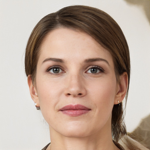 Joyful white young-adult female with medium  brown hair and grey eyes