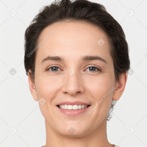 Joyful white young-adult female with short  brown hair and brown eyes