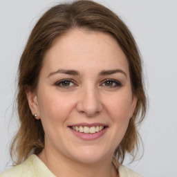 Joyful white young-adult female with medium  brown hair and brown eyes