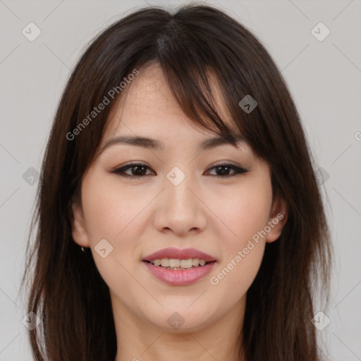 Joyful asian young-adult female with long  brown hair and brown eyes