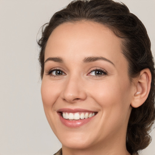 Joyful white young-adult female with medium  brown hair and brown eyes