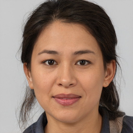 Joyful white adult female with medium  brown hair and brown eyes