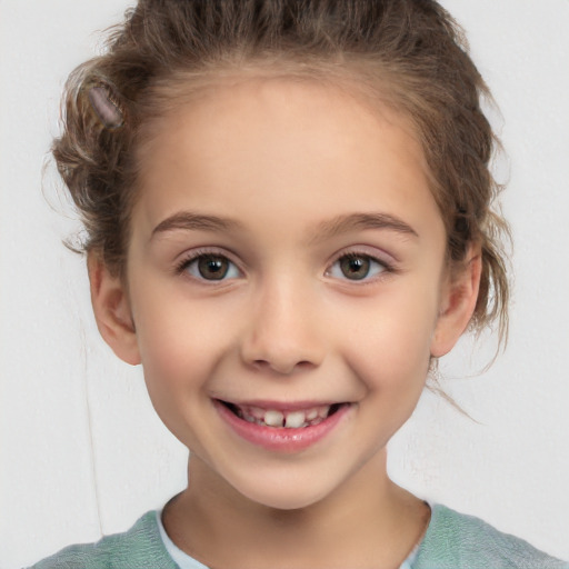 Joyful white child female with short  brown hair and brown eyes