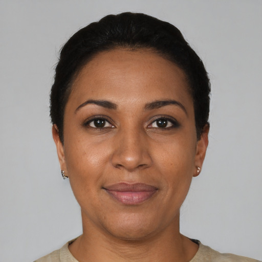 Joyful black young-adult female with short  black hair and brown eyes