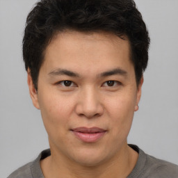 Joyful asian young-adult male with short  brown hair and brown eyes