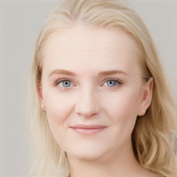 Joyful white young-adult female with long  brown hair and blue eyes