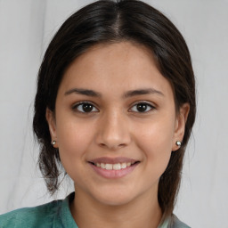 Joyful white young-adult female with medium  brown hair and brown eyes