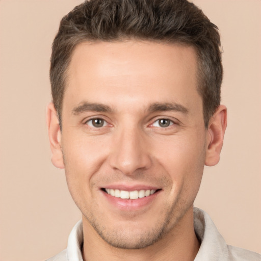 Joyful white young-adult male with short  brown hair and brown eyes