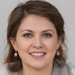 Joyful white young-adult female with medium  brown hair and grey eyes