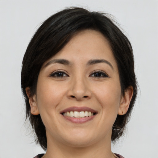 Joyful white young-adult female with medium  brown hair and brown eyes