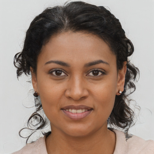 Joyful black young-adult female with medium  brown hair and brown eyes