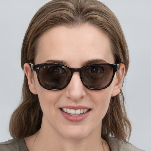 Joyful white young-adult female with medium  brown hair and blue eyes