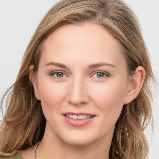 Joyful white young-adult female with long  brown hair and blue eyes