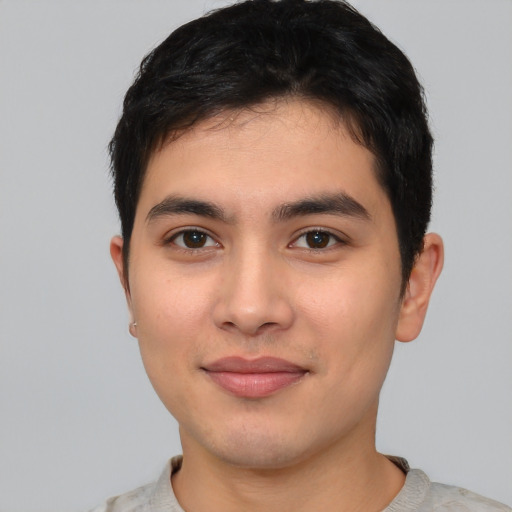 Joyful asian young-adult male with short  black hair and brown eyes