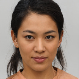 Joyful asian young-adult female with medium  brown hair and brown eyes