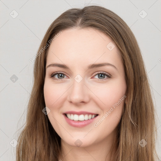 Joyful white young-adult female with long  brown hair and green eyes