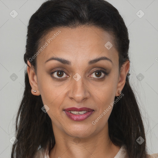 Joyful black young-adult female with long  brown hair and brown eyes