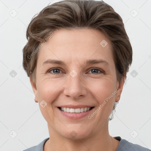 Joyful white adult female with short  brown hair and grey eyes