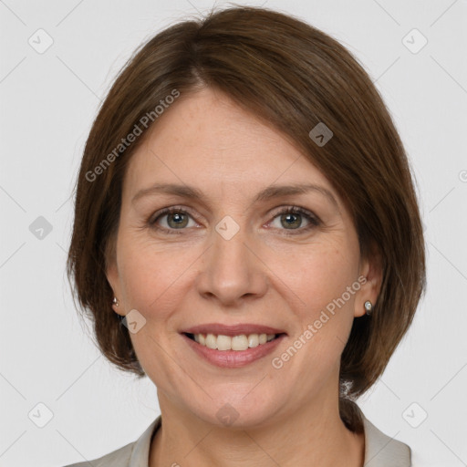 Joyful white adult female with medium  brown hair and grey eyes